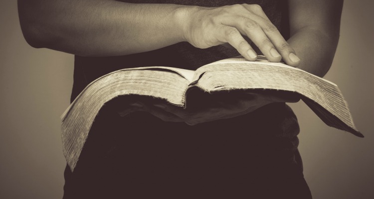 Vintage tone of man reading the Holy Bible.